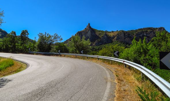 Winding road to San Leo city over hills, Romagna, Italy