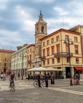 Rimini, Italy - June 14, 2017: The square Piazza tre Martiri with the ancient clock tower in Rimini, Italy