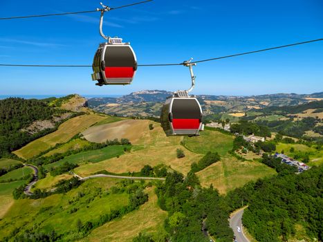 Two cabins of the funicular over countryside of San Leo, Italy