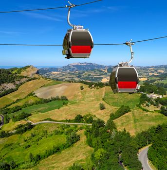 Two cabins of the funicular over countryside of San Leo, Italy