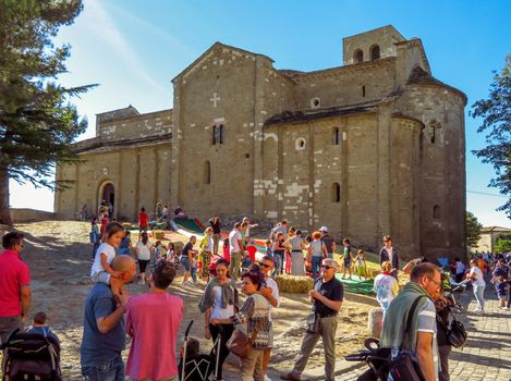 San Leo, Italy - June 18, 2017: The Cathedral of San Leo, Emilia Romagna, Italy. Unidentified people on a city holiday.