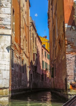 View from water canal to old buildings in Venice, Italy