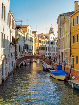 Venice, Italy - June 20, 2017: Beautiful canal in Venice with moorings and old houses.