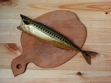 Smoked headless mackerel on a cutting board