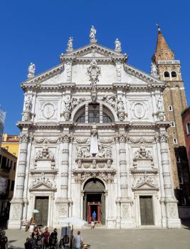 Venice, Italy - June 20, 2017: Unrecognized people walk near the Chiesa di San Moise, a Roman Catholic church built in the Baroque style in the 8th century.