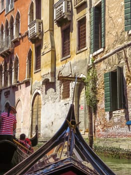 Venice, Italy - June 20, 2017: View from gondola to old buildings in Venice, Italy