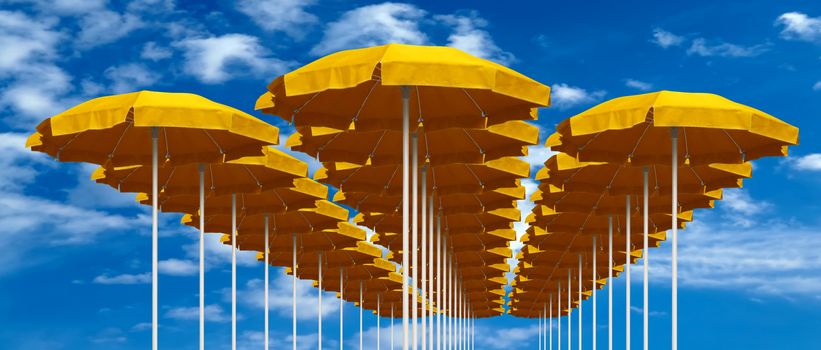 Yellow beach umbrellas under blue sky