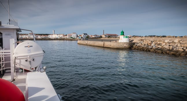 Ile d Yeu, France - September 16, 2018: View of the bridge of a ferry that enters the harbor of the island of Yeu where travelers are sitting to admire the show on a summer day