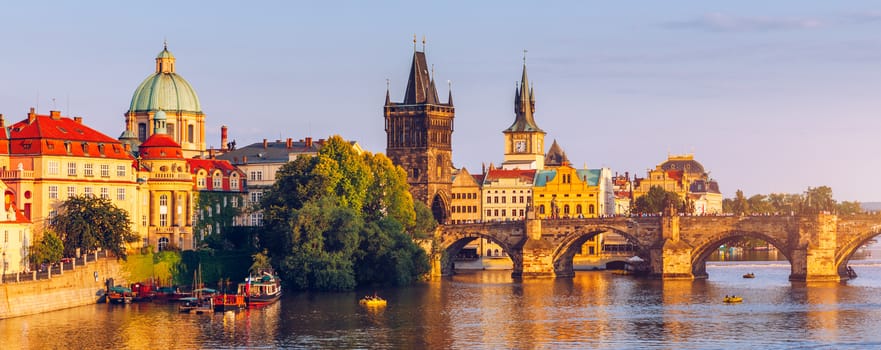 Scenic view of the Old Town pier architecture and Charles Bridge over Vltava river in Prague, Czech Republic. Prague iconic Charles Bridge (Karluv Most) and Old Town Bridge Tower at sunset, Czechia.