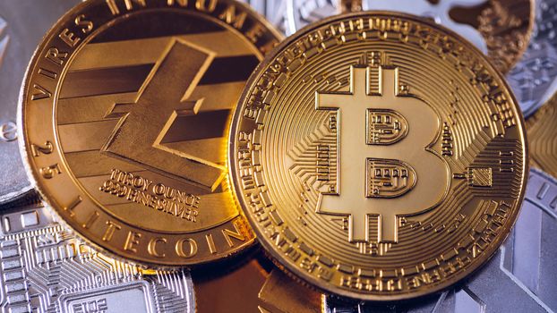 Stack of cryptocurrencies with a golden bitcoin. Bitcoin as most important cryptocurrency concept. Bitcoin. Physical bit coin. Digital currency. Cryptocurrency. Golden coin with bitcoin
