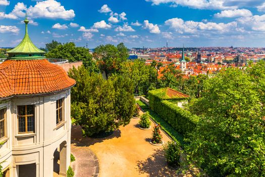 Prague red roofs and dozen spires of historical Old Town of Prague. Cityscape of Prague on a sunny day. Red rooftops, spires and the Charles Bridge and Vltava River in the background. Prague, Czechia.