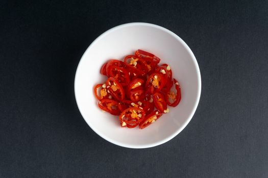 Spicy slice of red chillies closeup on black background