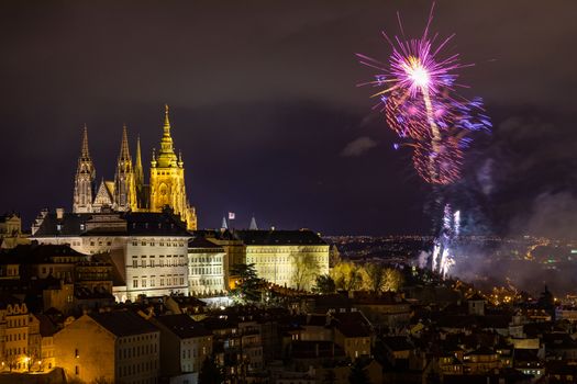 Fireworks over the Old Town of Prague, Czech Republic. New Year fireworks in Prague, Czechia. Prague fireworks during New Year Celebration near St. Vitus Cathedral, Prague, Czech republic.