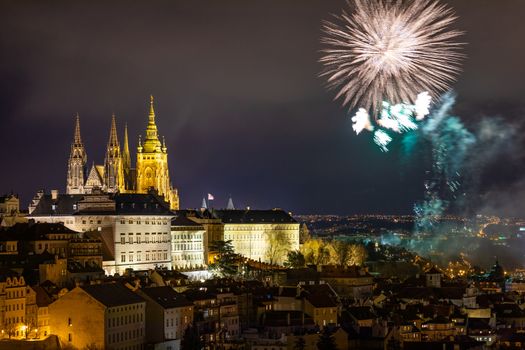 Fireworks over the Old Town of Prague, Czech Republic. New Year fireworks in Prague, Czechia. Prague fireworks during New Year Celebration near St. Vitus Cathedral, Prague, Czech republic.