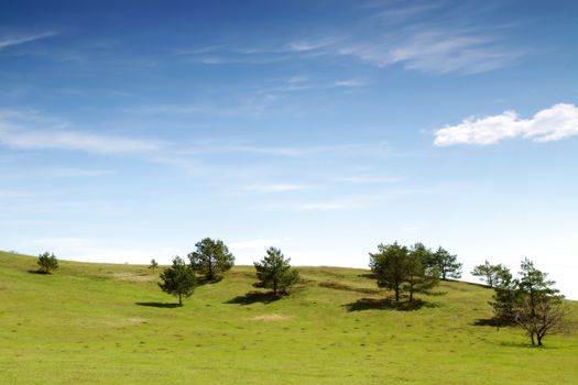 Beautiful summer landscape with green hills and blue sky.