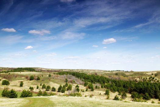 Beautiful summer landscape with green hills and blue sky.