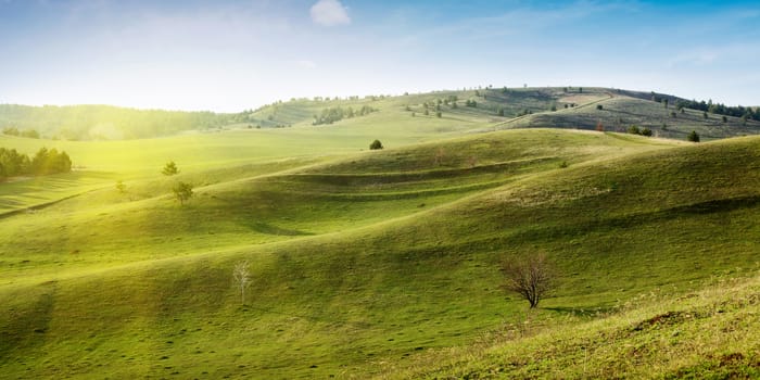 Beautiful summer landscape with green hills and blue sky.