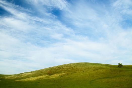 Beautiful summer landscape with green hills and blue sky.