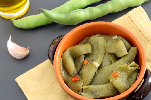 Cooked broad bean pods