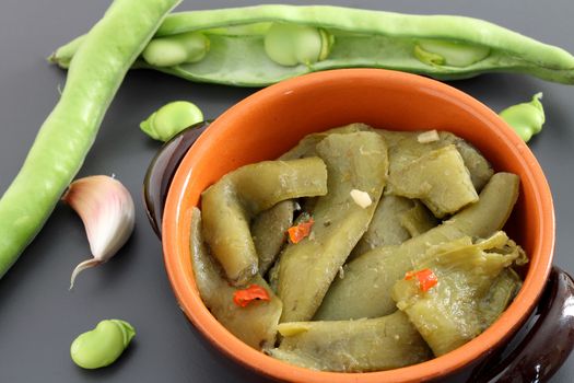 Cooked broad bean pods