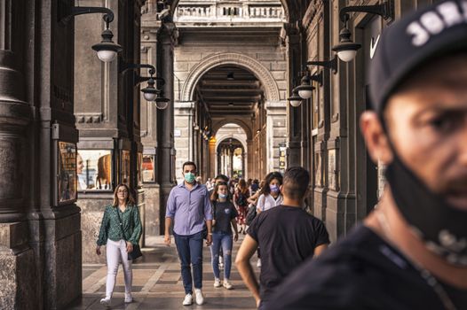 BOLOGNA, ITALY 17 JUNE 2020: People walking under Bologna's Arcades in Italy