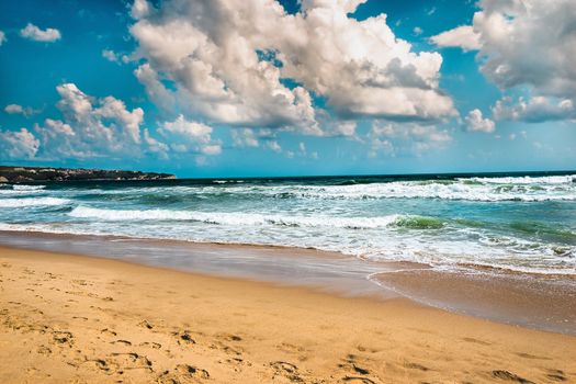 Seascape cloudy scene. Tropical  scenery with sand, wave of sea or ocean. calm paradise, relaxation, with splash of water and blue sky landscape, Amazing dramatic nature background of beach and sea 