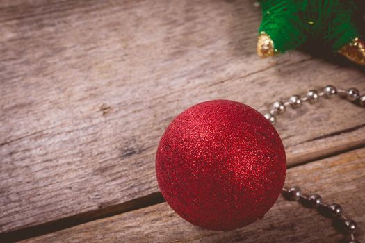 merry christmas concept with red decoration on old wooden board