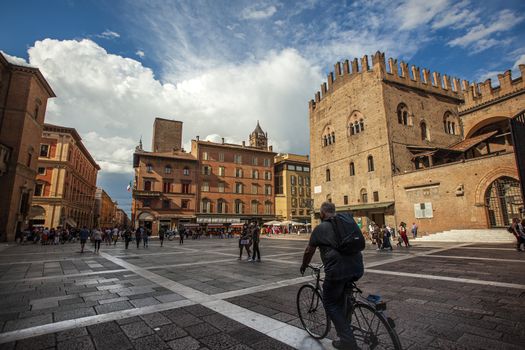 BOLOGNA, ITALY 17 JUNE 2020: Palazzo Re Enzo: a famous historic building in Bologna, Italy with people walking in the square