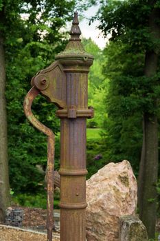 hand water pump Retro style. Manual vintage construction in green park 