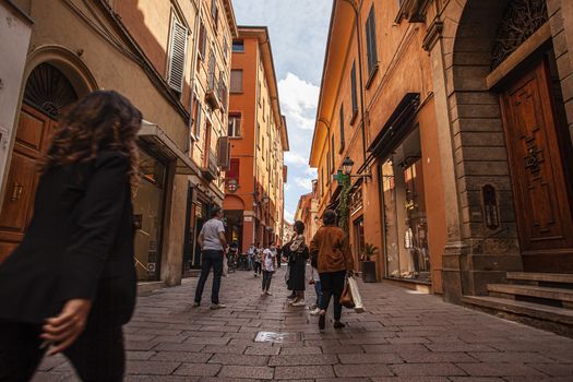 BOLOGNA, ITALY 17 JUNE 2020: Bologna alley detail with people walking