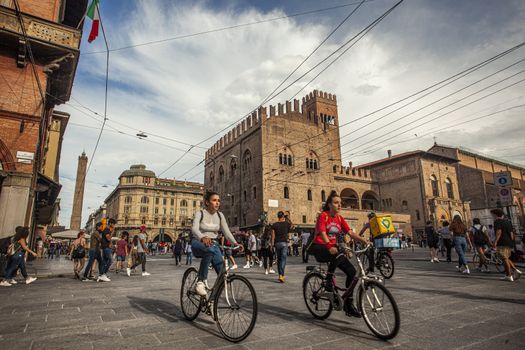 BOLOGNA, ITALY 17 JUNE 2020: Palazzo Re Enzo: a famous historic building in Bologna, Italy with people walking in the square