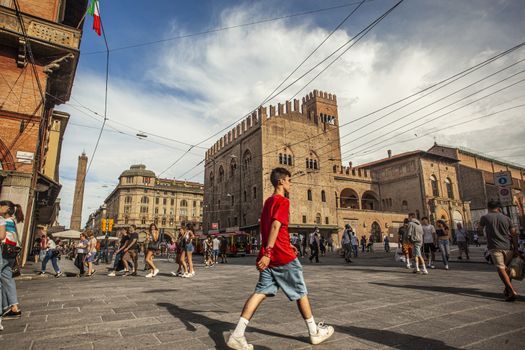 BOLOGNA, ITALY 17 JUNE 2020: Palazzo Re Enzo: a famous historic building in Bologna, Italy with people walking in the square