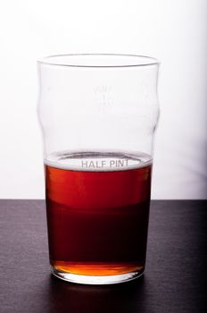 A beer glass half full