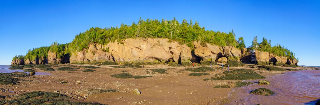 Hopewell Cape, Canada - September 24, 2018: Panoramic view of Hopewell Rocks at low tide, with visitors. New Brunswick, Canada