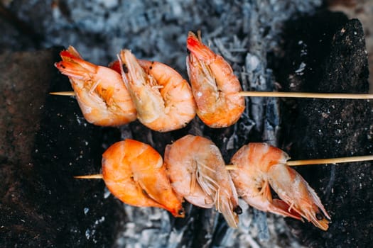 King prawns grilled on charcoal. Food outdoors. Cooking at the stake. Picnic