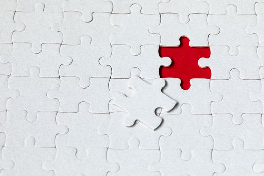 Closeup of jigsaw puzzle isolated. Missing jigsaw puzzle piece, business concept for completing the puzzle piece. Group of puzzle and a puzzle piece. Teamwork concept. Think difference concept. 