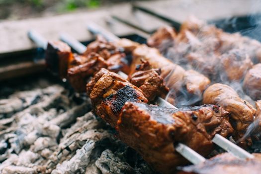 Skewers of pork ribs and chicken on skewers. Grilled meat. Cooking outdoors.