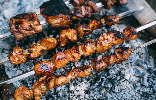 Skewers of pork ribs and chicken on skewers. Grilled meat. Cooking outdoors.