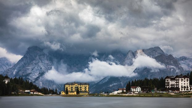 Misurina Lake in the Dolomites mountains in Italy near Auronzo di Cadore on a cloudy day, Sorapiss mountain in the background. South Tyrol, Dolomites, Italy.