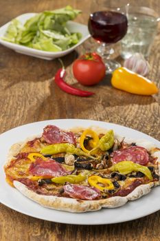 homemade pizza with red wine and salad