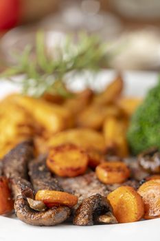 steak slices with carrots and fries