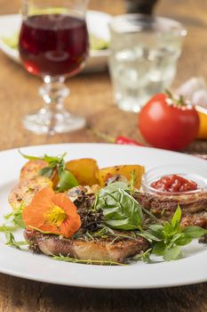 grilled veal cutlet with a nasturtium flower