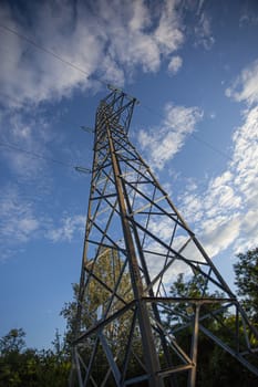 Electric pylon from below with blue sky