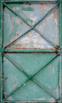 Old rusty gate with a crosshair