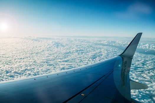 Wing of an airplane against a background of dense clouds