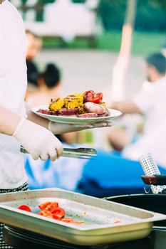 Grilling vegetables for an outdoor party