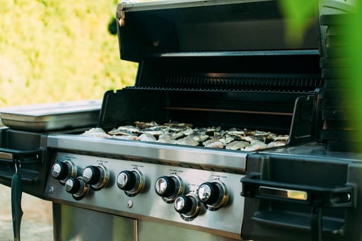 Grilling street fish. Food at an open-air party.