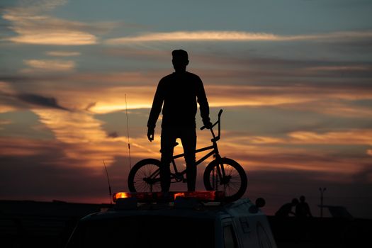 Cyclist on sunset background  Ski jumping competitions