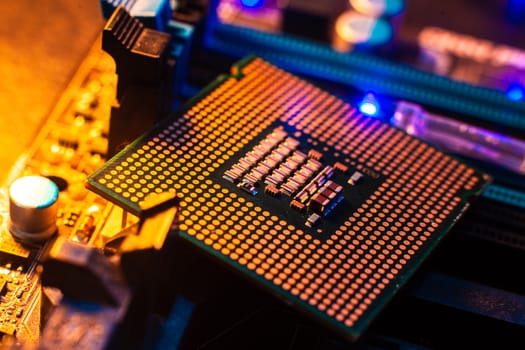 Processor with neon light. Large photo with blue-yellow light on a dark background.