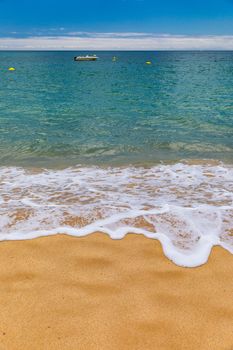 Blue ocean wave on sandy beach. Soft wave of blue ocean on sandy beach. Background. Top view of Beautiful beach with tranquil wave, sea and ocean background, summer vacation concept. 